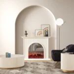 Olivia Electric Fireplace with arched opening and fluted molding, set in a modern living room with a black swivel chair and round coffee table.