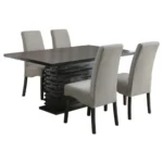 An angled view of the 5-piece dining room set, focusing on the unique pedestal table base and the upholstered chairs.