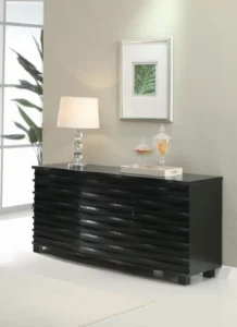 Sleek black sideboard with a unique wave-textured front in a modern dining room setting.