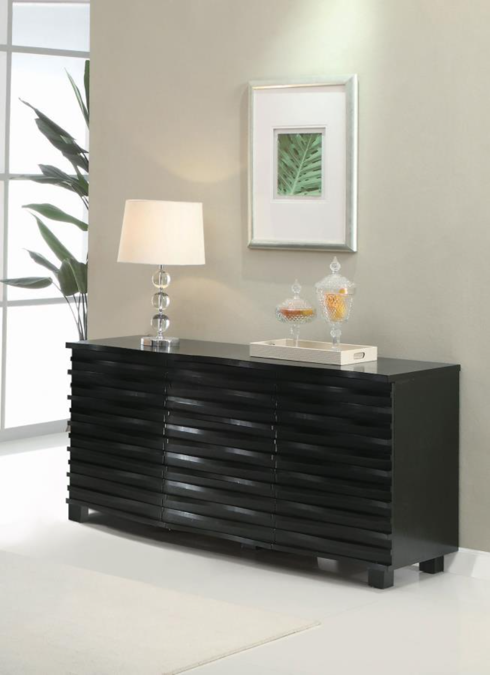 Sleek black sideboard with a unique wave-textured front in a modern dining room setting.