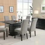 The Stanton black sideboard featured in a fully styled modern dining room with a table and chairs.