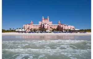 Iconic pink Don CeSar Hotel on St Pete Beach Florida with white sand and blue sky