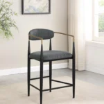 Set of 2 Tina Fabric Upholstered Dark Grey Counter Stools with Black Tapered Legs and Gold Arm Accents in Room