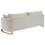 Corliss beige velvet sofa with gold legs and curved arms
