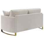 Corliss beige velvet loveseat with curved arms and gold legs
