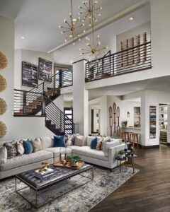 Bright and spacious living room with an elegant sectional sofa, modern decor, and contemporary lighting.