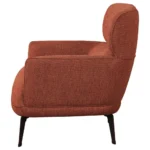 Close-up of the black metal leg on the orange modern chair.