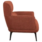 Close-up of the rounded track arm on the orange accent chair.