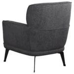 Three-quarter back view of a grey accent chair with a cushioned backrest.