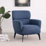 Modern blue accent chair with crescent arms and black legs in a living room setting.