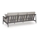 Angled back view of Akcay gray outdoor sofa showing vertical aluminum slat back design, wood-tone armrest, and sturdy legs
