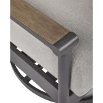 Close-up detail of Akcay aluminum gray outdoor sofa showing wood-tone armrest top, powder-coated frame curve, and gray Nuvella fabric texture