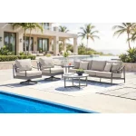 Akcay gray aluminum outdoor furniture collection arranged on a luxury poolside patio with swivel chairs, tables, and ocean view