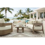 Amos 3 seater outdoor sofa collection arranged on poolside patio with swivel chair, loveseat, coffee table, and ocean view in background