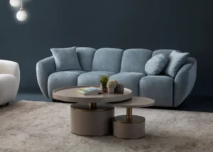 A modern ice gray boucle sofa with a curved sofa design, in an elegant living room setting.