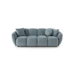 A modern ice gray boucle sofa with a curved sofa design, in an elegant living room setting.