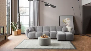 A modern gray boucle sectional sofa with a curved design in a stylish living room.
