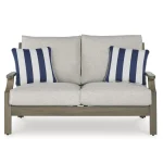 Front view of Milas beige aluminum outdoor loveseat with two seat cushions and blue striped accent pillows on white background