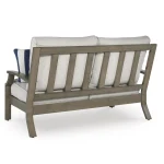 Angled back view of Milas beige aluminum outdoor loveseat showing vertical slat design and curved armrests