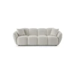 A modern white boucle sofa with a curved arm sofa design in a contemporary living room setting.