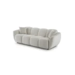 A modern white boucle sofa with a curved arm sofa design in a contemporary living room setting.