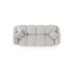 A modern white boucle sofa with a curved arm sofa design in a contemporary living room setting.