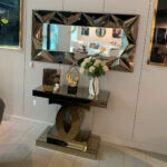 Bronze-tinted mirrored console table with luxurious design, perfect for entryways and living rooms.