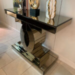 Bronze-tinted mirrored console table with luxurious design, perfect for entryways and living rooms.