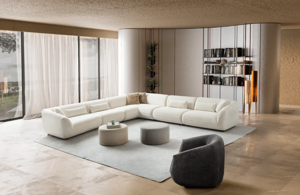 Large white modular sectional with round ottomans in a modern living room