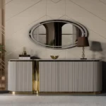 A close-up of the beige sideboard with gold details from the Cappadocia dining set, featuring a fluted design and oval mirror.