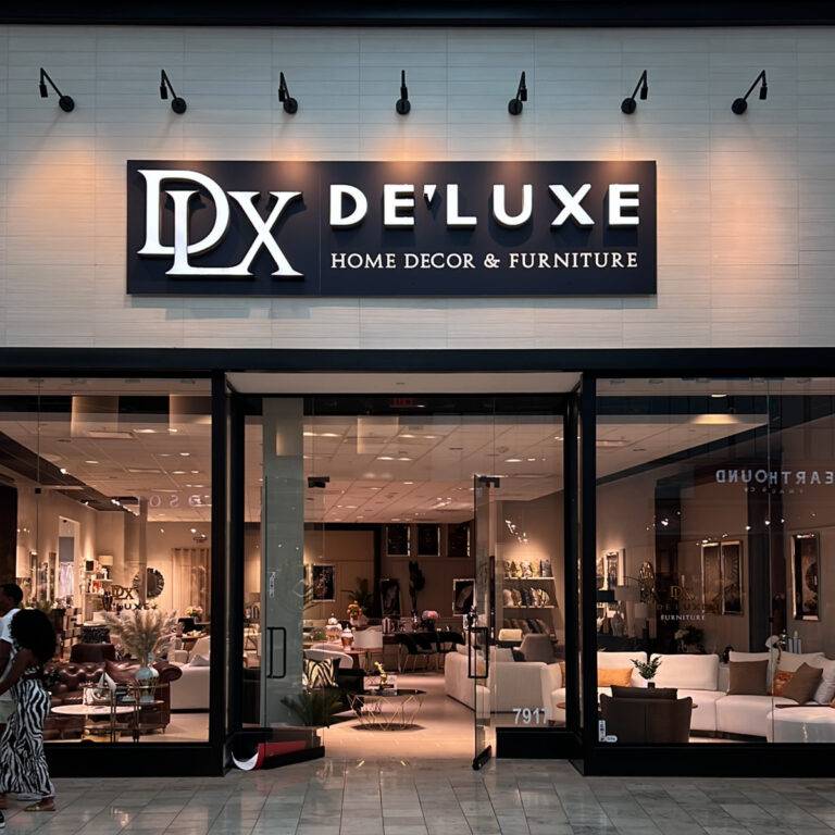 Modern storefront of De'Luxe Home Decor & Furniture, one of the top furniture stores near me in Citrus Park Mall, Tampa, featuring elegant living room and dining displays.