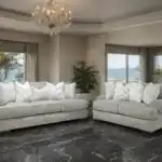 Transitional Nerone Light Gray Sofas in a luxury living room with chandelier and ocean view.