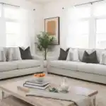 Romsey Light Gray Sofa and Loveseat set with track arms and accent pillows in a bright transitional living room.