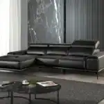 Modern Vadso Black Leather Sectional Sofa left chaise, sleek black design with metal legs, displayed in Tampa furniture store.