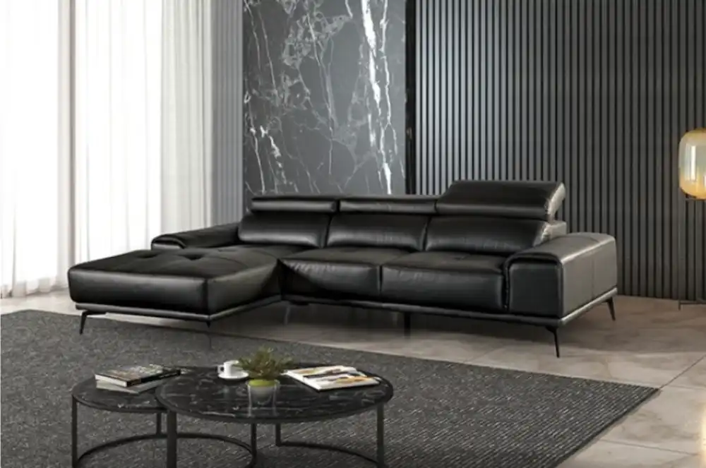 Modern Vadso Black Leather Sectional Sofa left chaise, sleek black design with metal legs, displayed in Tampa furniture store.
