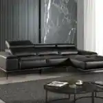Modern Vadso Black Leather Sectional Sofa right chaise, sleek black design with metal legs, displayed in Tampa furniture store.