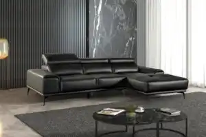Modern Vadso Black Leather Sectional Sofa right chaise, sleek black design with metal legs, displayed in Tampa furniture store.