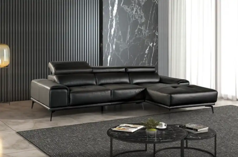 Modern Vadso Black Leather Sectional Sofa right chaise, sleek black design with metal legs, displayed in Tampa furniture store.