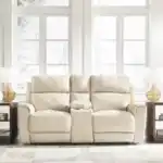 Dahlmoore Power Reclining Loveseat w/ Console in an almond tone, setting the scene for a light and modern living room furniture setup. The centerpiece of a Tampa home.