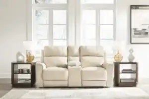 Dahlmoore Power Reclining Loveseat w/ Console in an almond tone, setting the scene for a light and modern living room furniture setup. The centerpiece of a Tampa home.