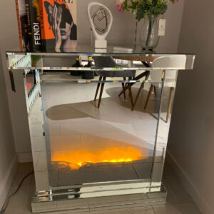 Chic mirrored fireplace console with ambient lighting and decorative features