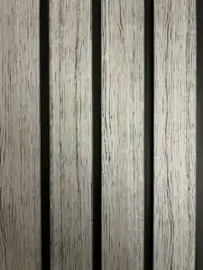Wood looking silver gray PVC wall panel with black fluted channels, modern decorative interior wall solution.