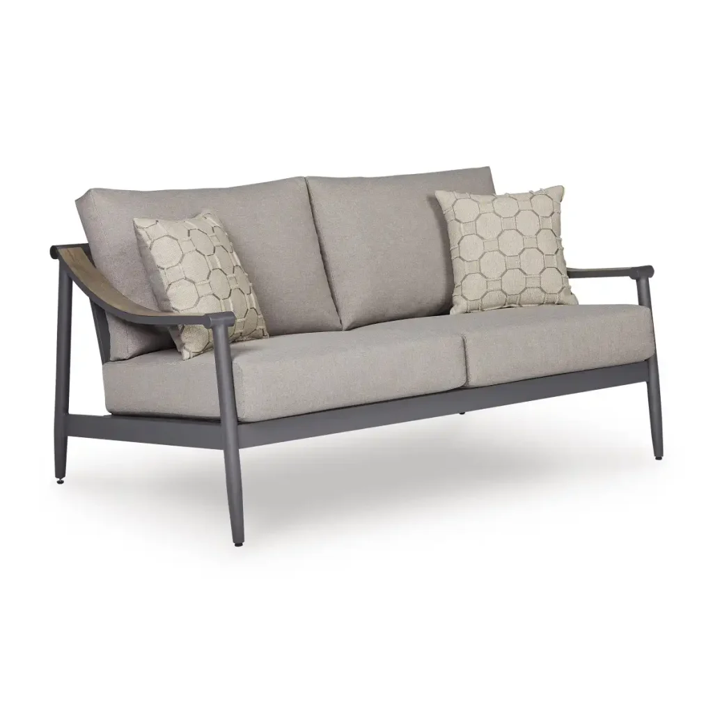 Three-quarter angle view of Akcay gray aluminum outdoor loveseat with wood-tone armrest accent and hexagon throw pillows