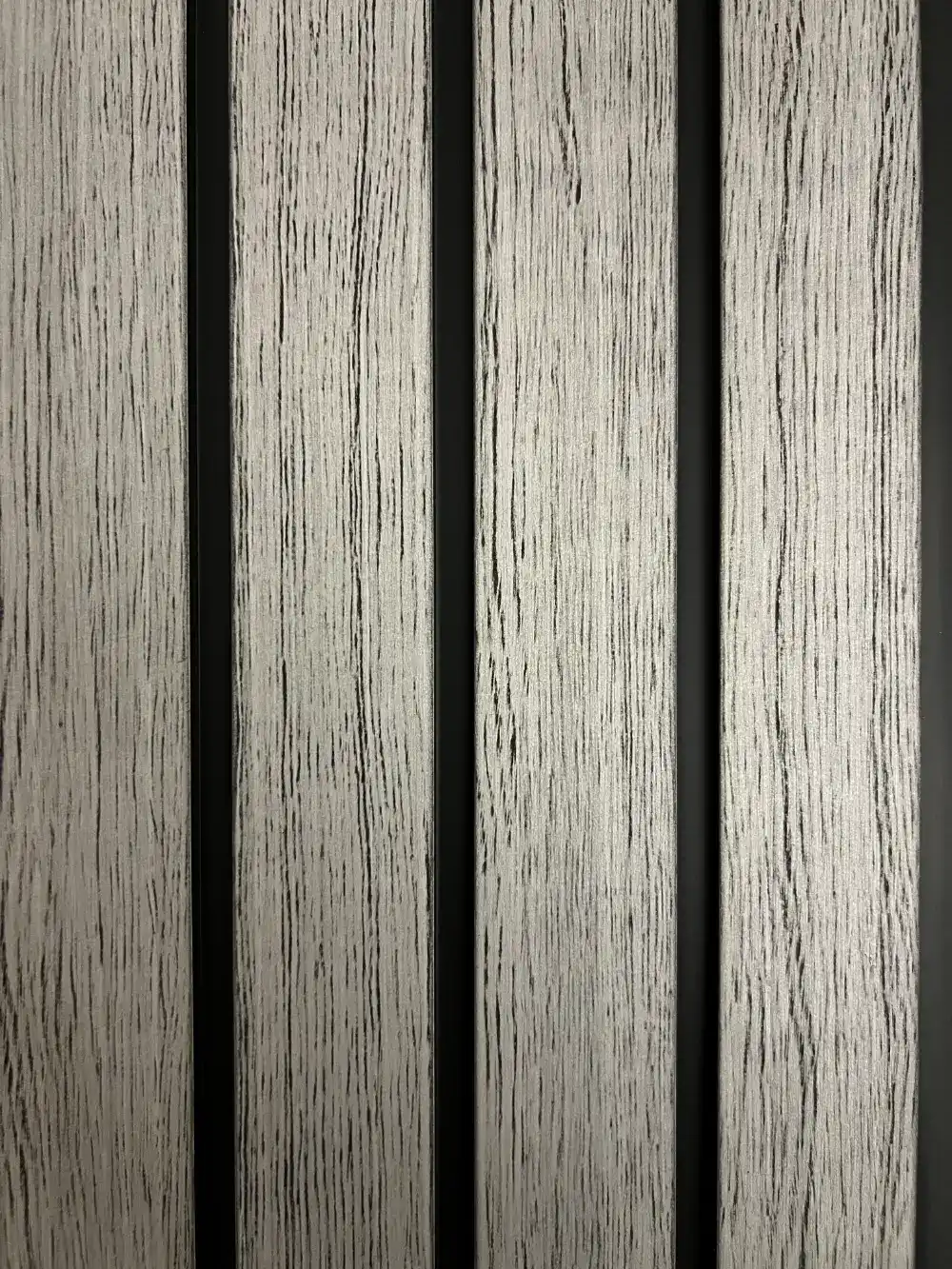 Wood looking silver gray PVC wall panel with black fluted channels, modern decorative interior wall solution.