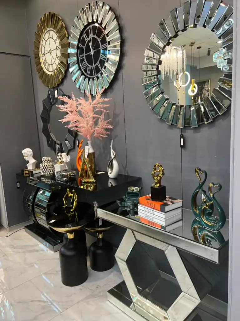 Interior view of a Tampa luxury home decor store featuring gold and silver accessories, decorative trays, vases, accent mirrors, and modern wall clocks.