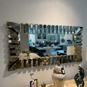 Large rectangular accent wall mirror with a gold and beveled mirrored frame design, reflecting the dining room in the modern home decor store in Tampa, De'Luxe Home Decor & Furniture.
