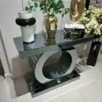 World Console Gray mirrored console with round reflective base, showcasing premium detail and decor styling on top.