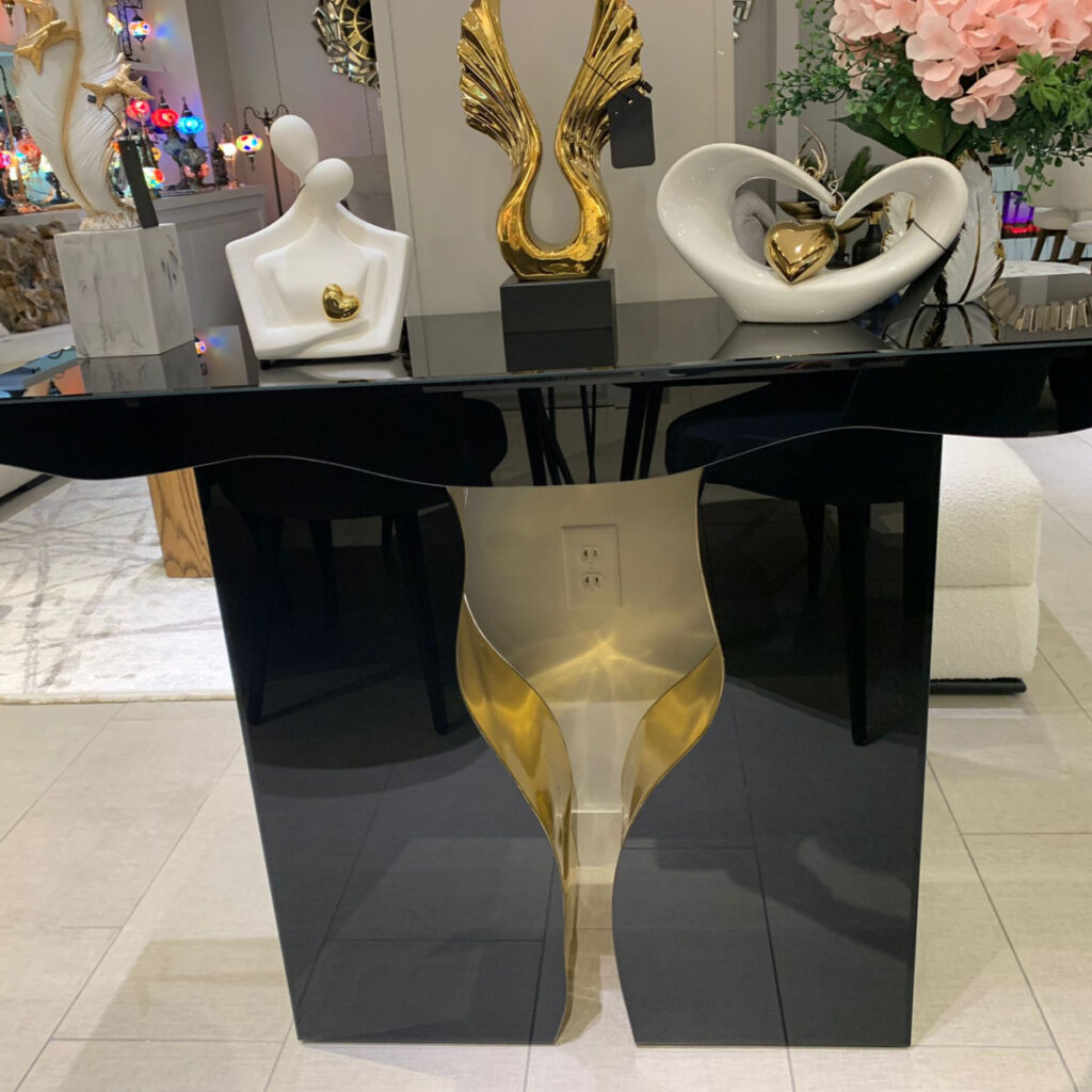 Elegant Italian black and gold console table adorned with decorative items