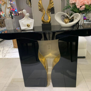 Elegant Italian black and gold console table adorned with decorative items