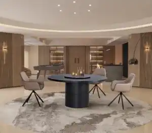 Modern round black dining table with four beige swivel chairs on a patterned rug in a contemporary Tampa dining area.